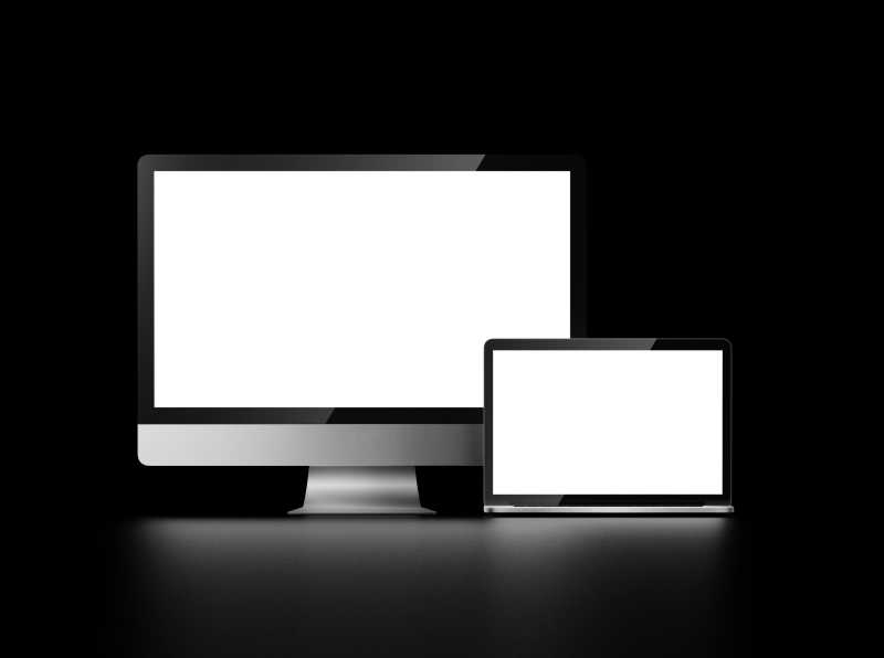 黑色背景下的两个一大一小白色屏幕的电脑