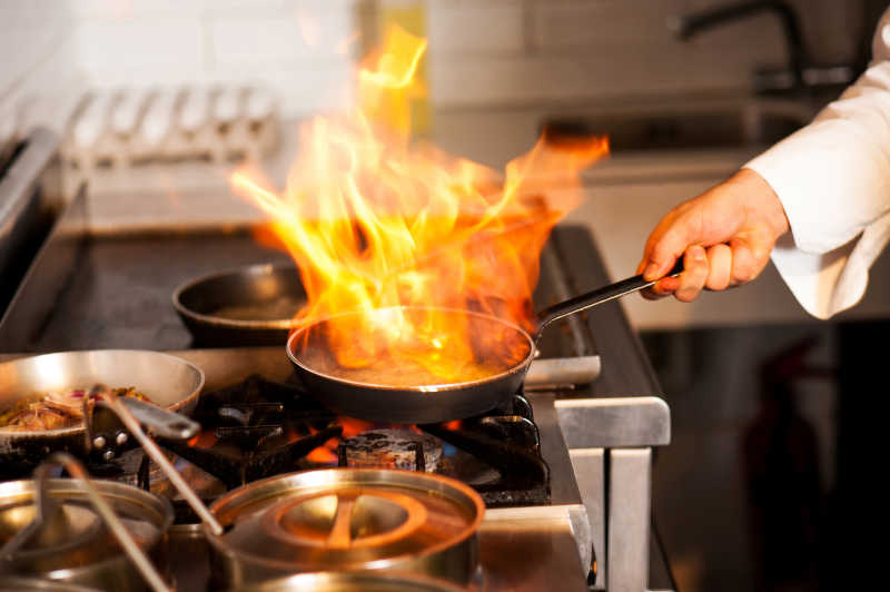 厨师用厨灶烹饪产生的火焰