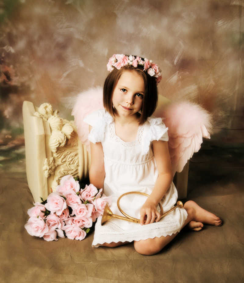 美丽的小女孩带着花环和翅膀像个天使