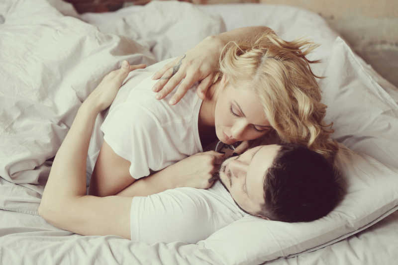 床上互相亲密拥抱的夫妇