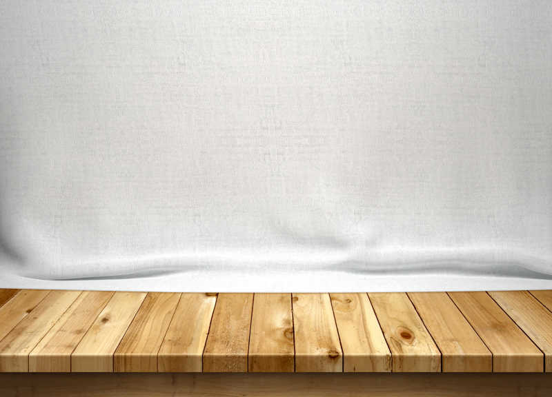 白色窗帘前的老式木桌
