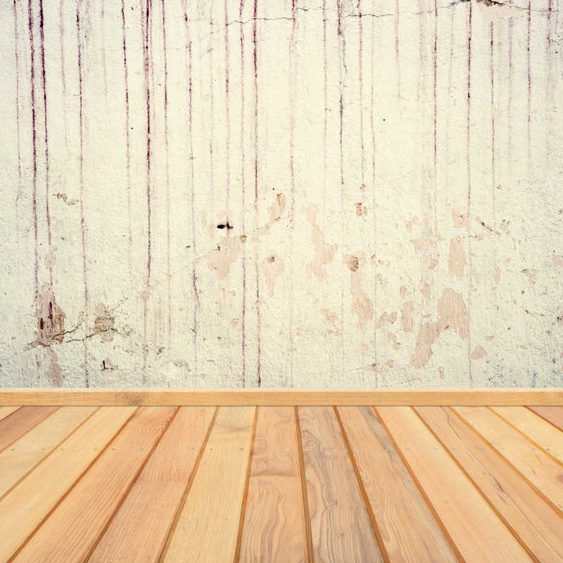 白色的旧混泥土墙和木地板连接背景