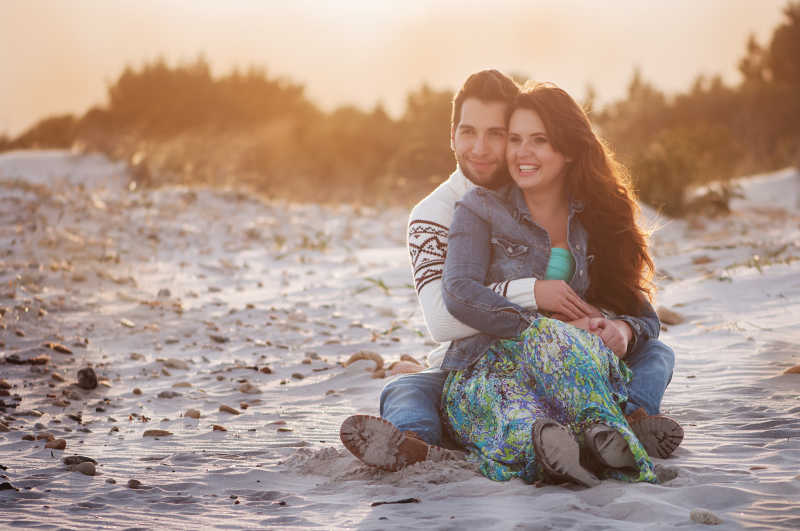日落海滩的年轻夫妇