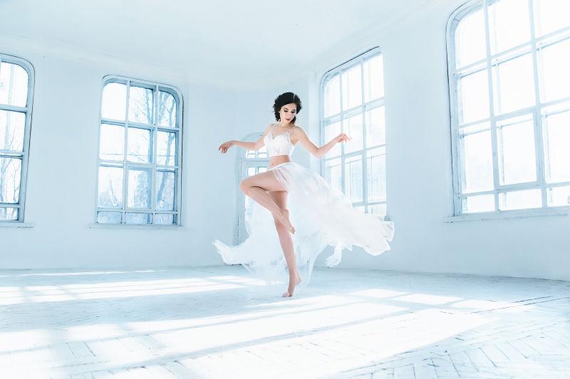 穿白纱的美女在宽敞的房间里跳舞