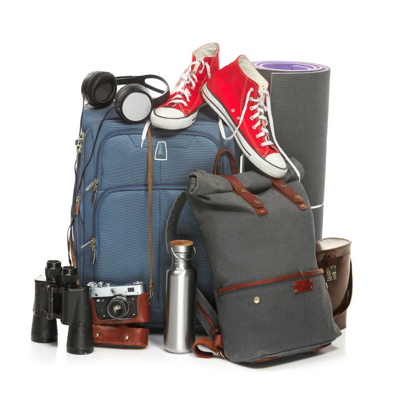 蓝色旅行箱运动鞋背包以及望远镜等旅游必备物品