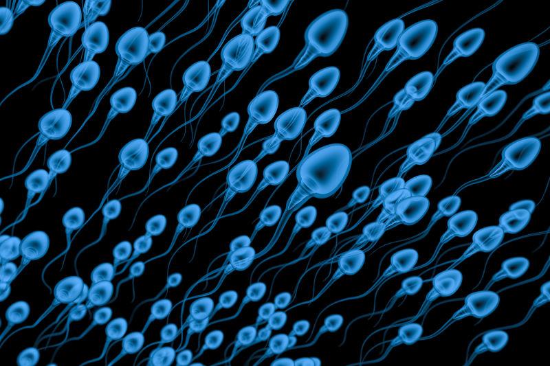 黑色背景上的蓝色精子细胞群