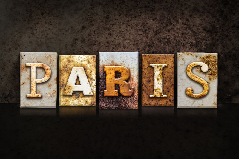 “巴黎”这个词是在生锈的金属凸版上用深色纹理的背景写出来的