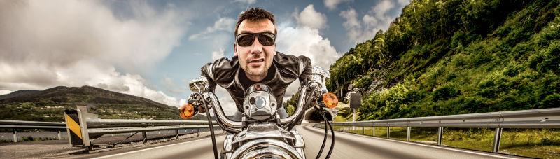滑稽的戴着太阳镜骑摩托车的男人