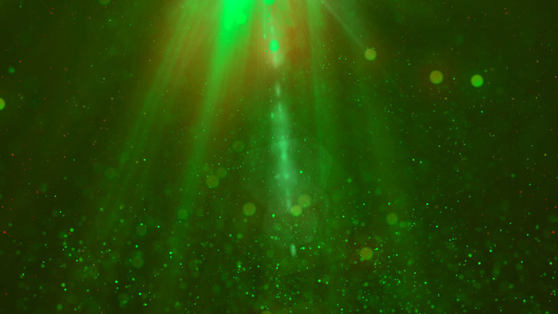 带粒子抽象背景的绿色魔法烟雾灯