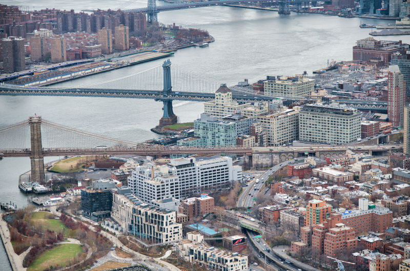从直升机的角度看纽约市在多云的日子里布鲁克林和曼哈顿的大桥和曼哈顿的摩天大楼