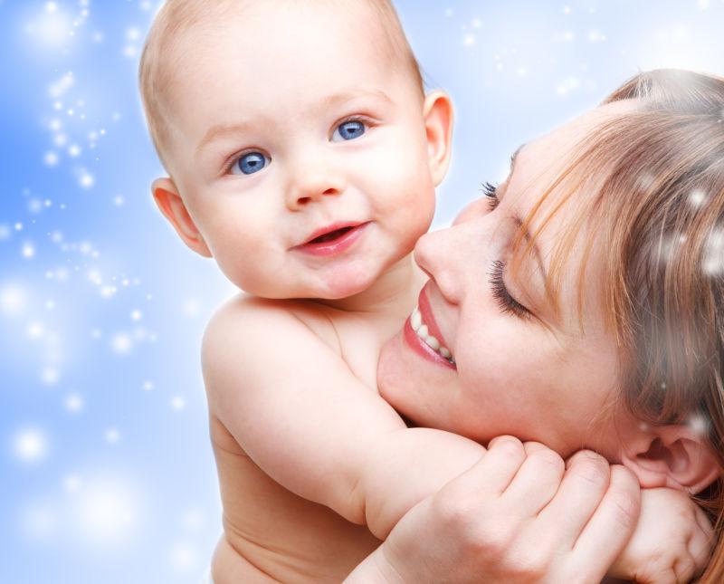 蓝雪背景下天使宝宝和母亲的肖像