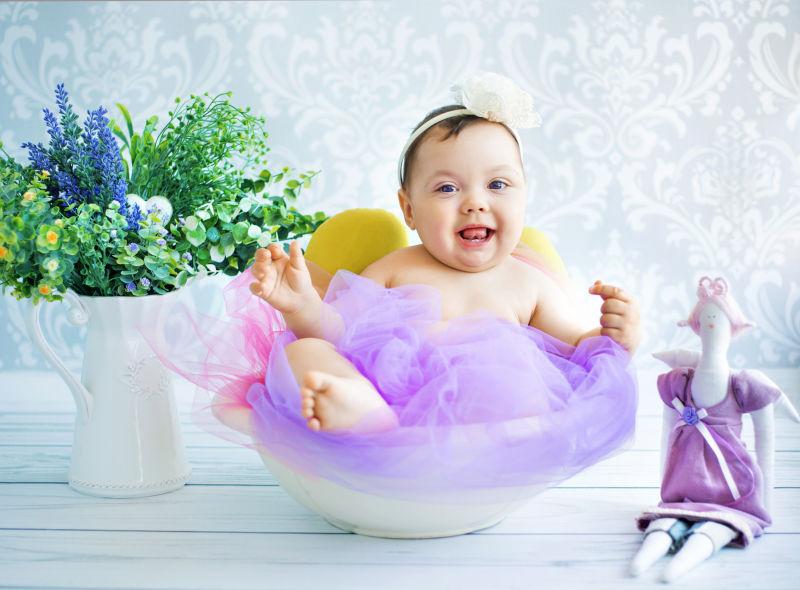 白色瓷盆里穿着紫纱裙的孩子的写真